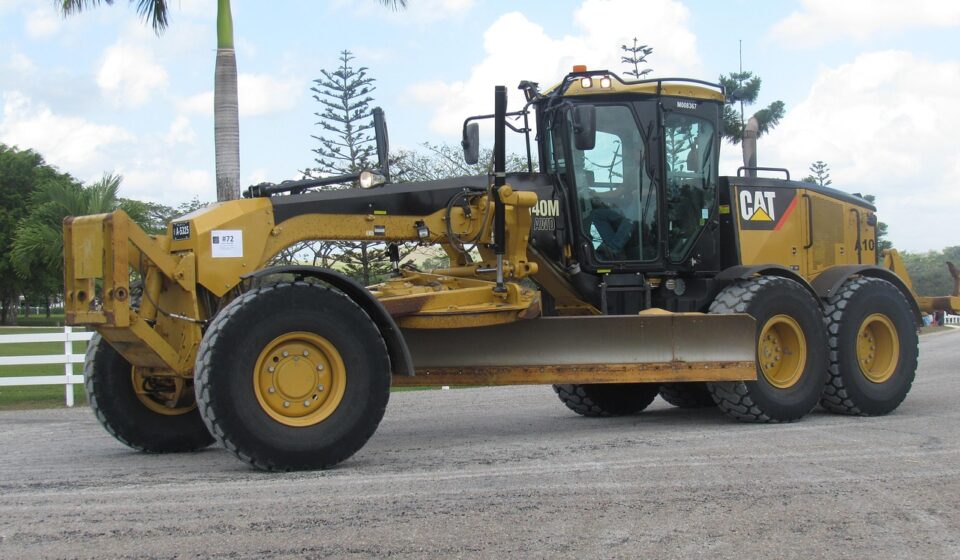 grader, machine, animal, pet, tractor, heavy, vehicle, transportation system, construction, power, equipment, cat, building, road, yellow, industrial