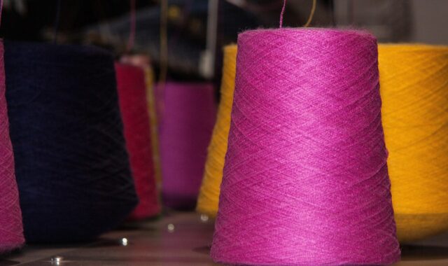 coil, yarns, flat knitting machine, knit, fully automatic, automatic, computer controlled, pink, yellow, red
